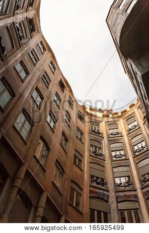 BARCELONA, SPAIN - SEPTEMBER 28 2006: Looking upwards within the atrium of a Gaudi design Barcelona apartment block.