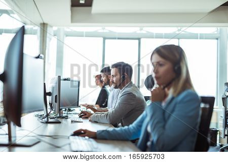 Colleagues working in a call centre in the office.