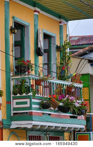 September 22, 2016 FIlandia, Colombia: colonial style balcony decorated with blooming flowers in the coffee producing town