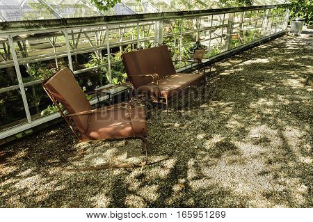 New Bedford Massachusetts USA - May 25 2016: Retro lawn chairs under tree offer reminder of earlier times at Allen C. Haskell Public Gardens