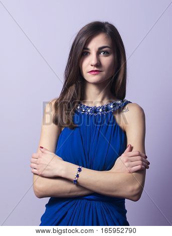 Portrait of a beautiful girl in a blue dress
