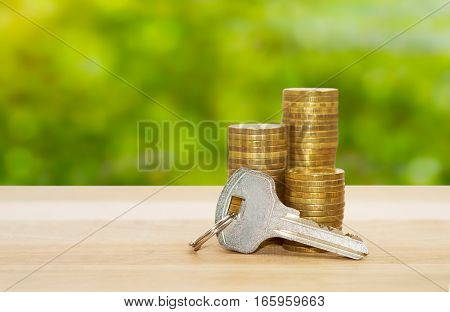 real-estate concept money coins stack with key