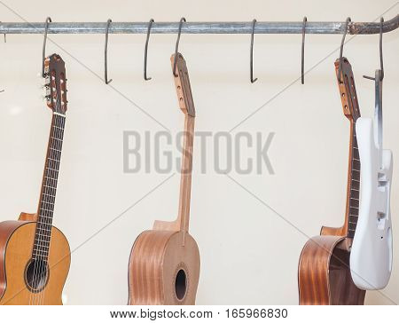 a row of classical unfinished guitar at workshop.