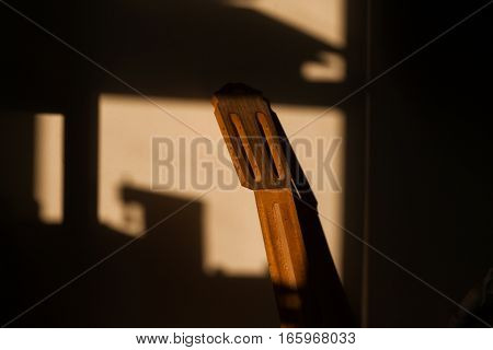 unfinished vulture guitar in sunlight at workshop.