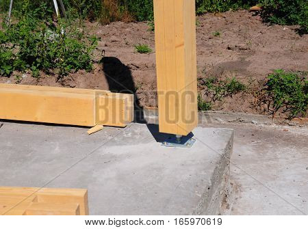 Wooden pillar on the construction site concrete with screw. Wooden Pillars are structures that can be placed on Foundations or Platforms.