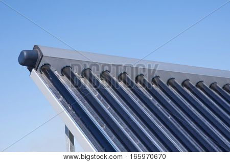 Closeup of vacuum solar water heating system on the house roof.Energy efficiency