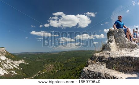 BAKHCHISARAY REPUBLIC of CRIMEA RUSSIA - SEPTEMBER 13.2016: Tourists posing against the backdrop of the mountains