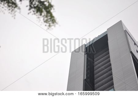 Architecture Tower in grey panelling against Foggy Sky