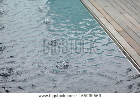 Reflective Pool Edge Detail. Steel edge. Timber Deck. Water