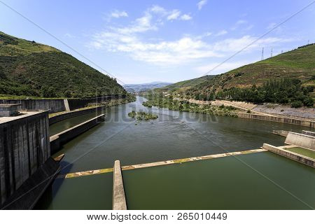 Downstream View Of The Douro River From The Top Od The Regua Dam, All Called Bagauste Dam, Having Th