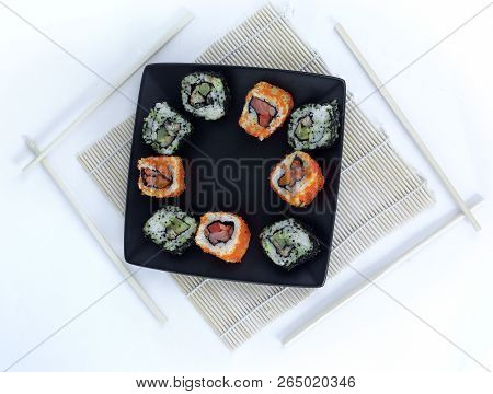 Different Types Of Maki Sushi On A Black Plate