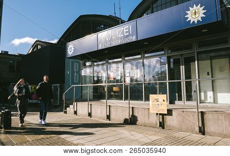 Hamburg, Germany - Mar 20, 2018: Man And Woman Passing By Police Polizei Station Near Hamburg Centra