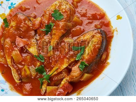 Machcha Besarou, Fried Fish Marinated In Turmeric And Cooked In Mustard, Garlic And Tomatoes Is A Ty