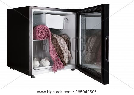 A Black Refrigerator With An Open Door, Inside The Refrigerator Is A Woolen Scarf And Christmas Deco