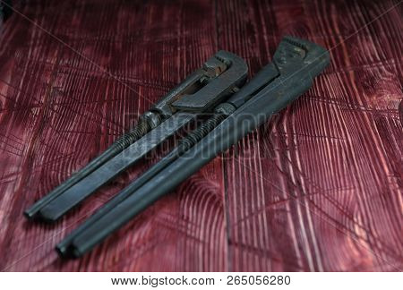 Tool On The Board Of Mahagany Background.