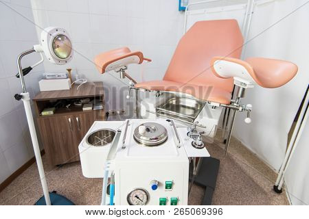 Gynecological cabinet with chair and other medical equipment in modern clinic