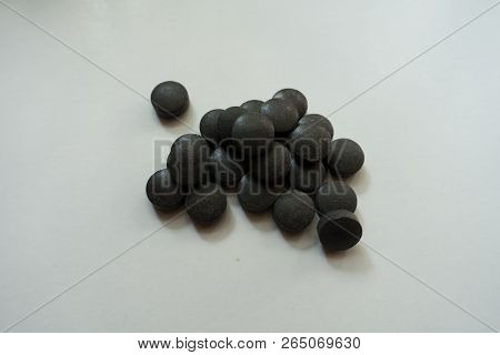 Chelated Iron Black Round Pills In A Heap