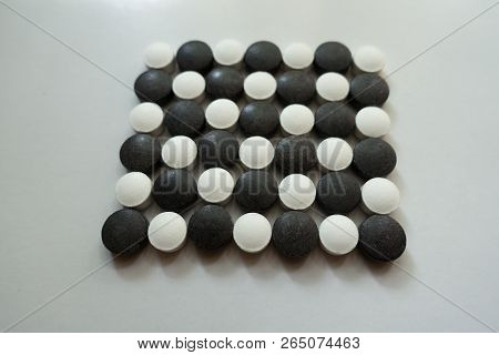 Closeup Of Check Pattern Made Of Black And White Pills