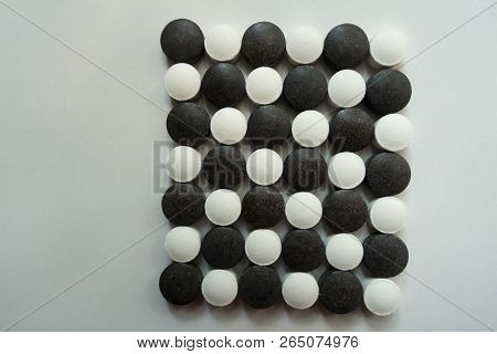 Top View Of Black And White Pills In Shape Of Checkerboard