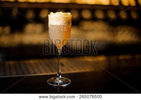 Sweet Wine Glass Filled With Delicious Brandy Crusta Cocktail On The Bar Counter Against Dark Backgr