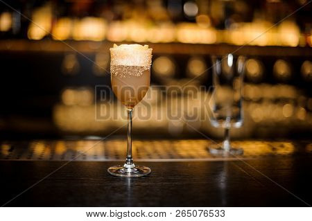 Sweet Wine Glass Filled With Delicious Sour Brandy Crusta Cocktail On The Bar Counter Against Dark B