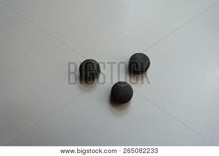 Group Of Three Round Black Pills Of Chelated Iron