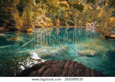 Autumn Time At Romantic Forest Lake Blausee, One Of The Best Known Mountain Lakes In Switzerland.
