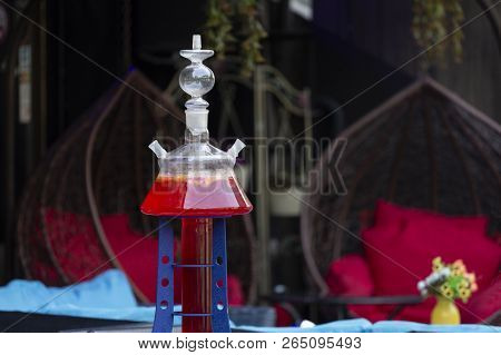 Glass Hookah With Red Juice On Dark Background