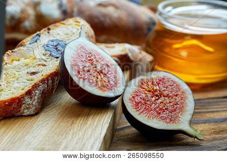 Cut Figs On A Wooden Board Watered With Honey. Rustic Style.