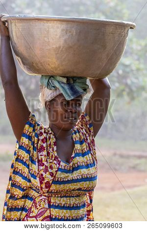 Ghana, Accra - January 02, 2017: African Ghana Woman Carries A Container Full Of Water On The Head I