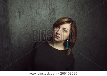 Vintage Portrait Of Beautiful Stylish Girl With Turquoise Earrings On Gray Studio Background.