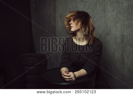 Vintage Portrait Of Beautiful Stylish Girl With Turquoise Earrings And Flying Hair On Gray Studio Ba