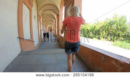 Bologna, Italy - September 29, 2018: A Sporty Woman Running Under San Lucas Porch: The Longest Porti
