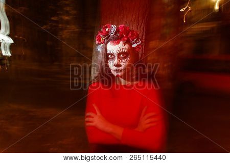 Blurry Body And Red Lantern. A Girl With A Painted Face Of A Skeleton, A Dead Zombie, In The City Du