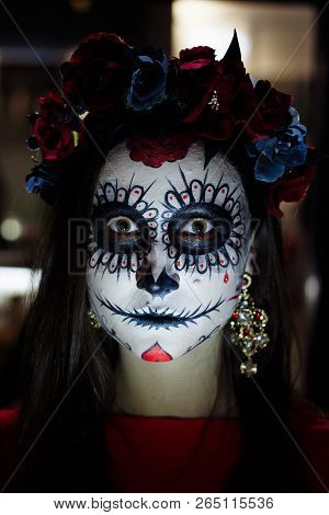 A Girl With A Painted Face Of A Skeleton, A Dead Zombie, In The City During The Day. Day Of All Soul
