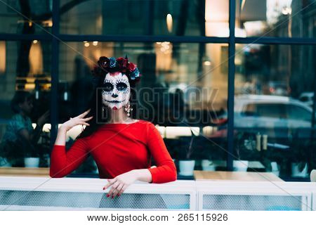 A Girl With A Painted Face Of A Skeleton, A Dead Zombie, In The City During The Day. Day Of All Soul