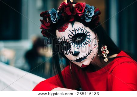 A Girl With A Painted Face Of A Skeleton, A Dead Zombie, In The City During The Day. Day Of All Soul