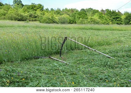 Tradition Scythe For Mowing The Green Grass On Meadow