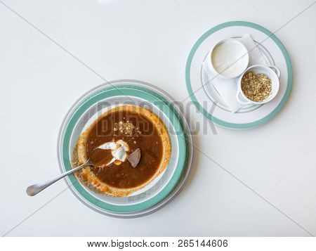 Meat Soup Kharcho With Nuts And Sour Cream On A White Table
