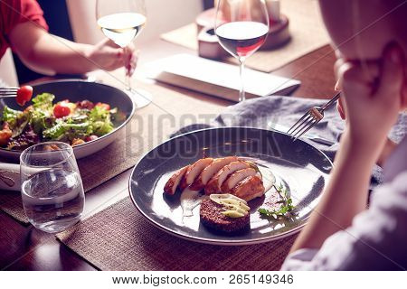 Beautiful Young Women With Glasses Of Red And White Wine In Luxury Restaurant. Dinner Or Lunch. Eati