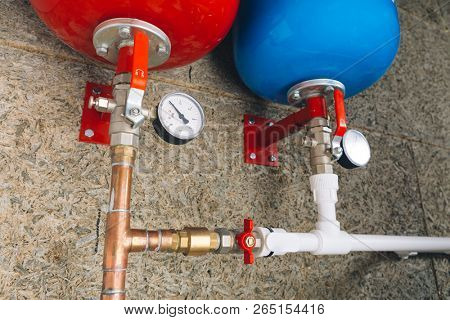 expansion tanks with pressure gauges in boiler room
