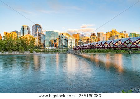 Skyline Of The City Calgary, Alberta, Canada Along The Bow River With Peace Bridge