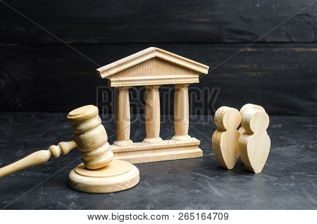 A Group Of People Standing Near The House Of Government And Judge's Gavel. Concept Of The Judicial S