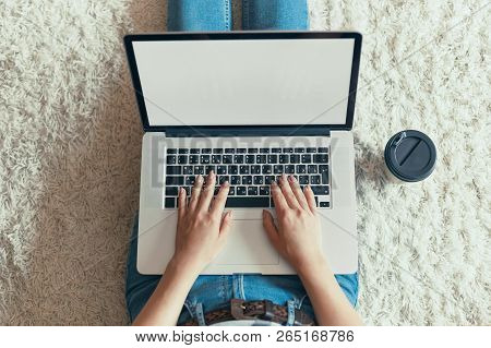 Woman Working On A Laptop. Female Using A Laptop Sitting On Floor, Searching Web, Browsing Informati