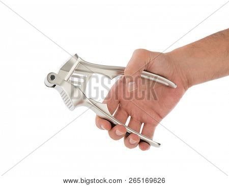 Male hand pressing garlic masher isolated on white background. 