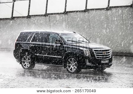 Moscow, Russia - May 2, 2018: Luxury Suv Cadillac Escalade In The City Street During A Heavy Rain.