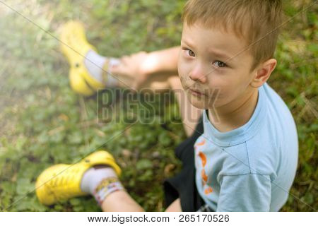 Sad crying little boy is looking in the camera
