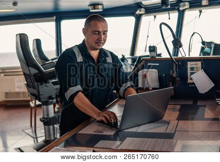 Marine Navigational Officer Is Using Laptop Or Notebook At Sea