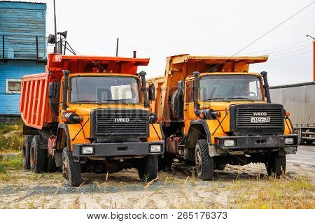 Gubkinsky, Russia - September 8, 2014: Orange Dump Trucks Iveco 330-30 Anw In The City Street.