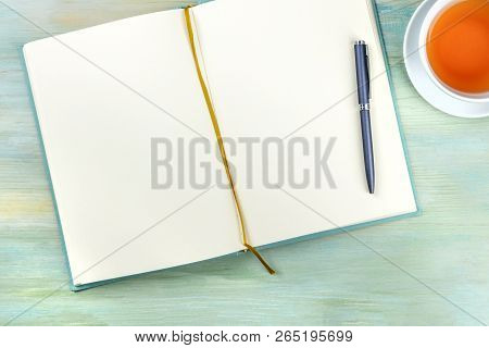 An Overhead Photo Of An Open Journal Notebook With A Pen And A Cup Of Tea, Shot From The Top, A Diar